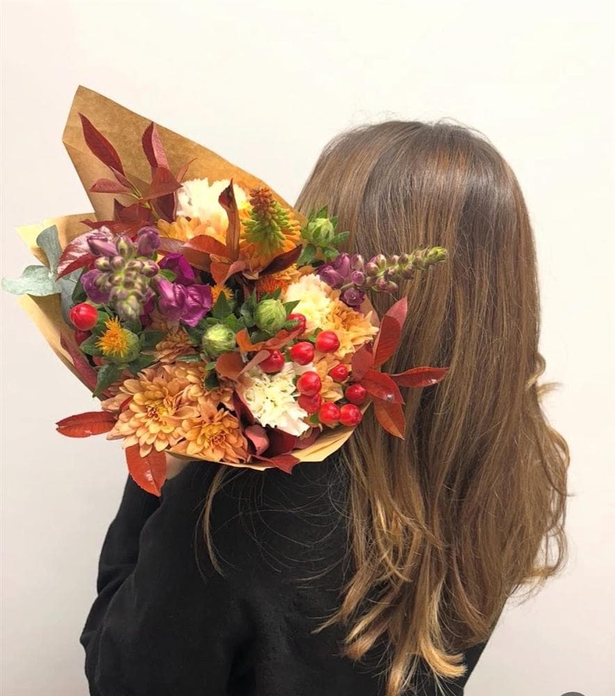 Autumn bouquet with warm orange flowers