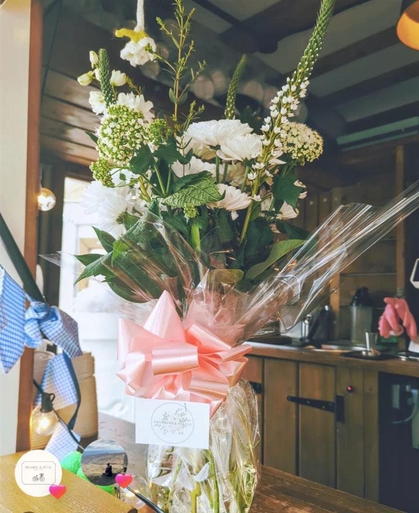 A white floral arrangement in a glass vase
