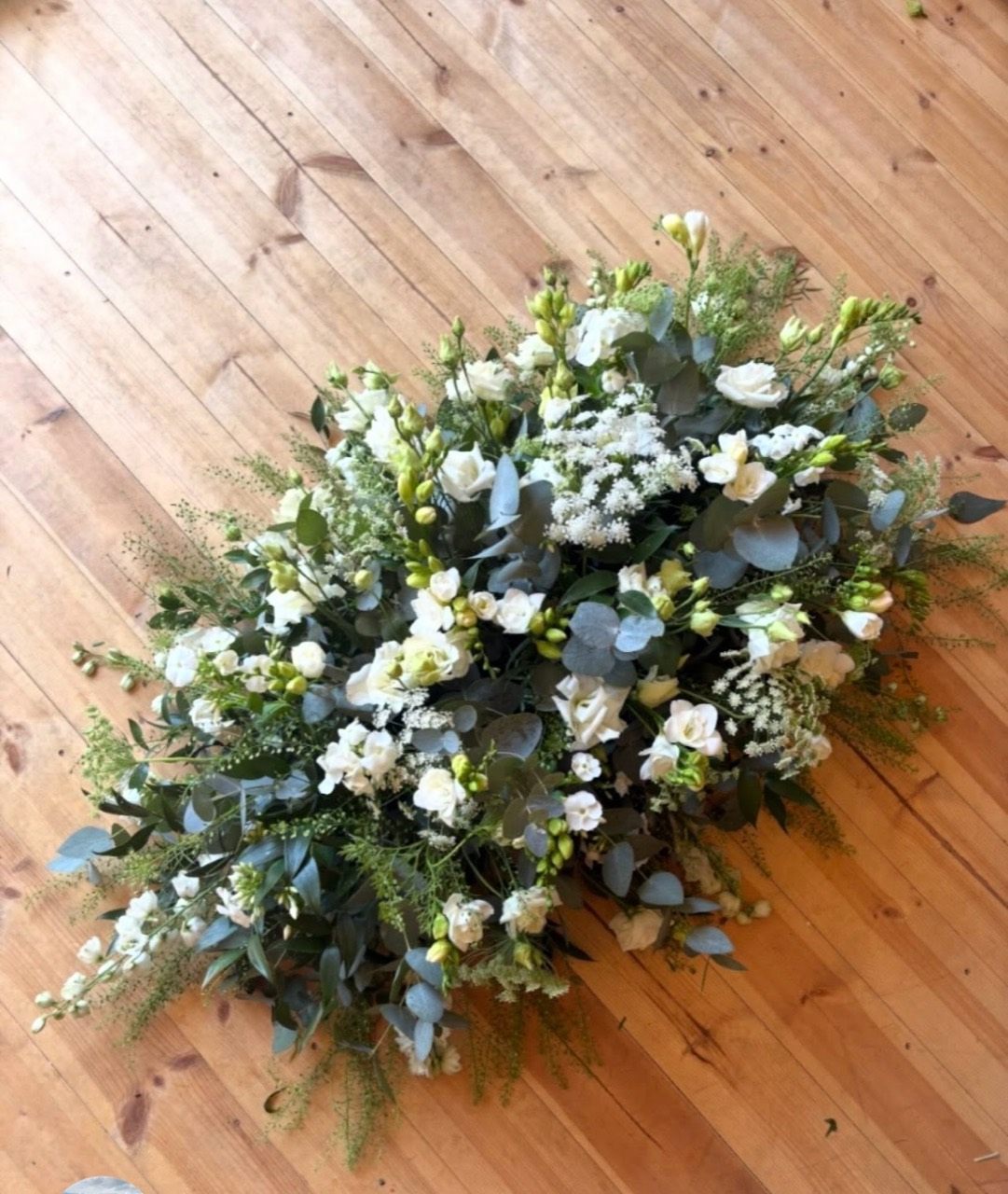 A natural white and green floral spray