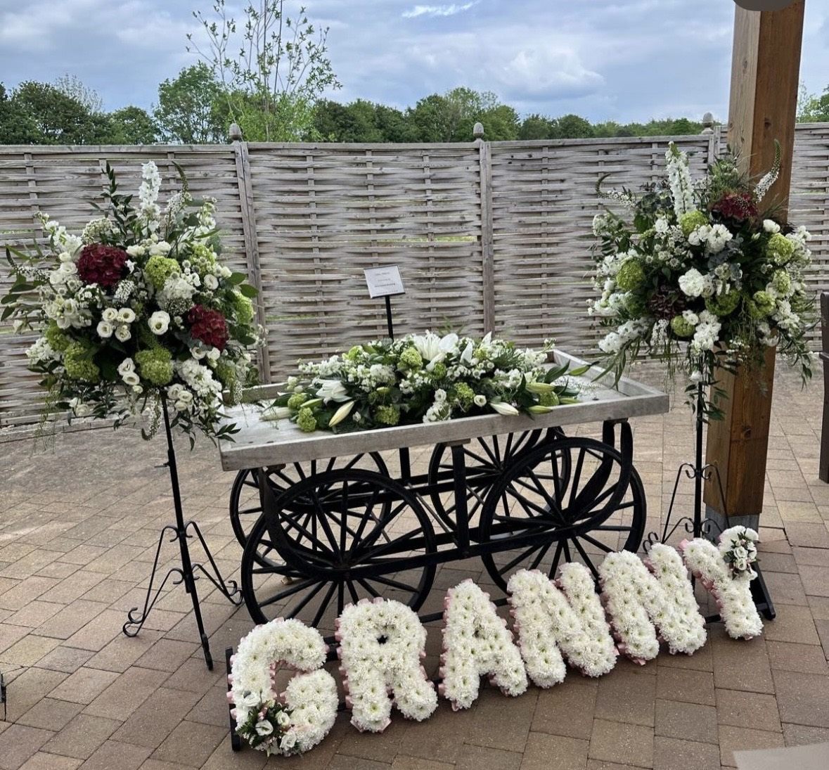 A floral funeral tribute and letter arrangement